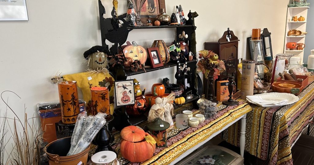 Halloween and fall decorations, pumpkins and dishes on sale tables inside the Haber Center