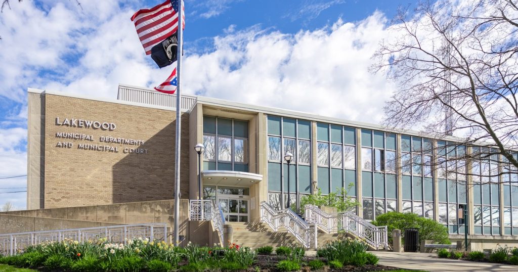 Lakewood City Hall on Detroit Avenue, a tan brick and glass building with flags flying out front